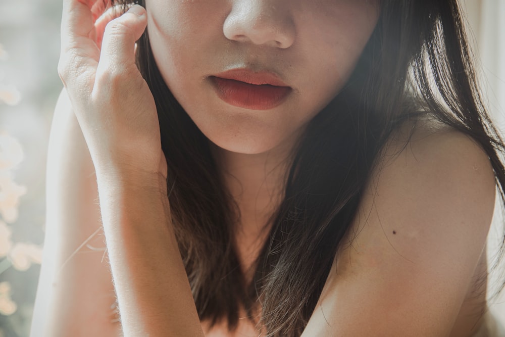 woman with black hair and wearing silver stud earrings