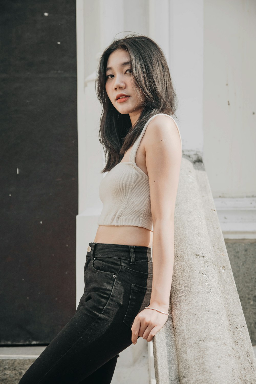 woman in white tank top and black denim shorts