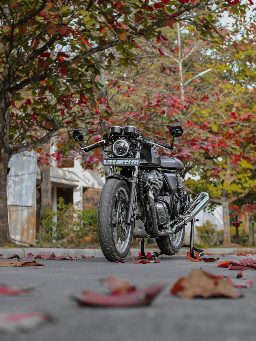 black motorcycle parked on sidewalk during daytime