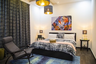 Stylish bedroom with fresh paint, elegant decor, and improved lighting after remodel