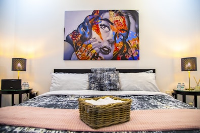 A stylish bedroom featuring cultural artwork and warm, inviting colors.