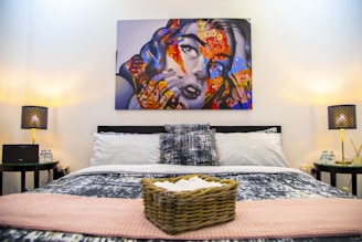 A stylish bedroom featuring decorative pillows and blankets.