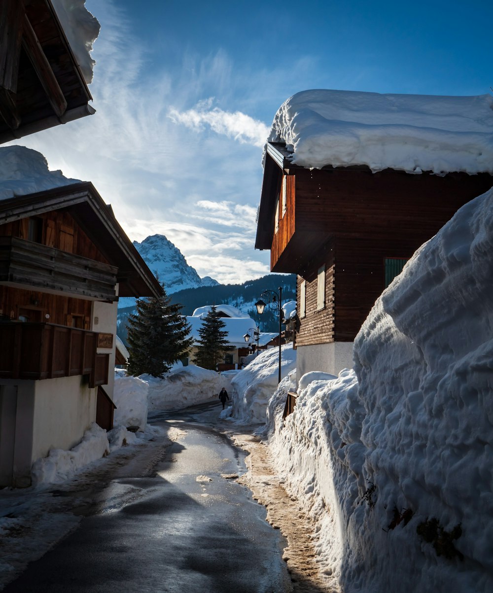 brown wooden house covered by snow during daytime