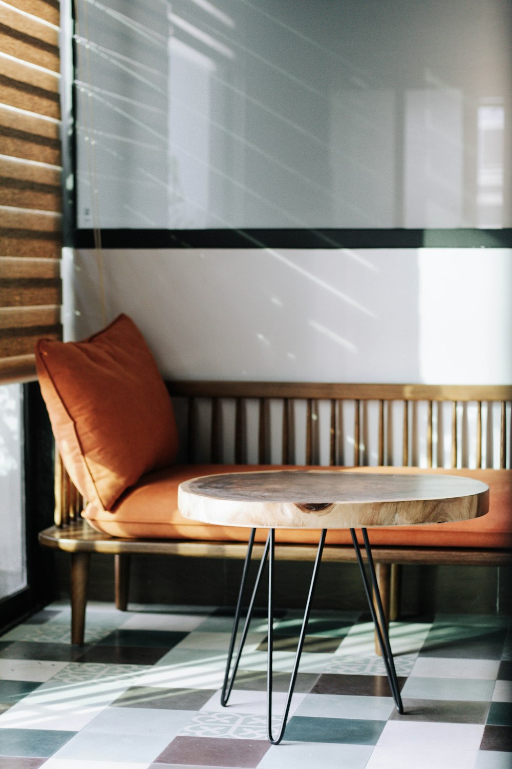 brown wooden table near white wall