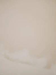 Soft textured background resembling gentle fabric in warm beige and ivory tones.