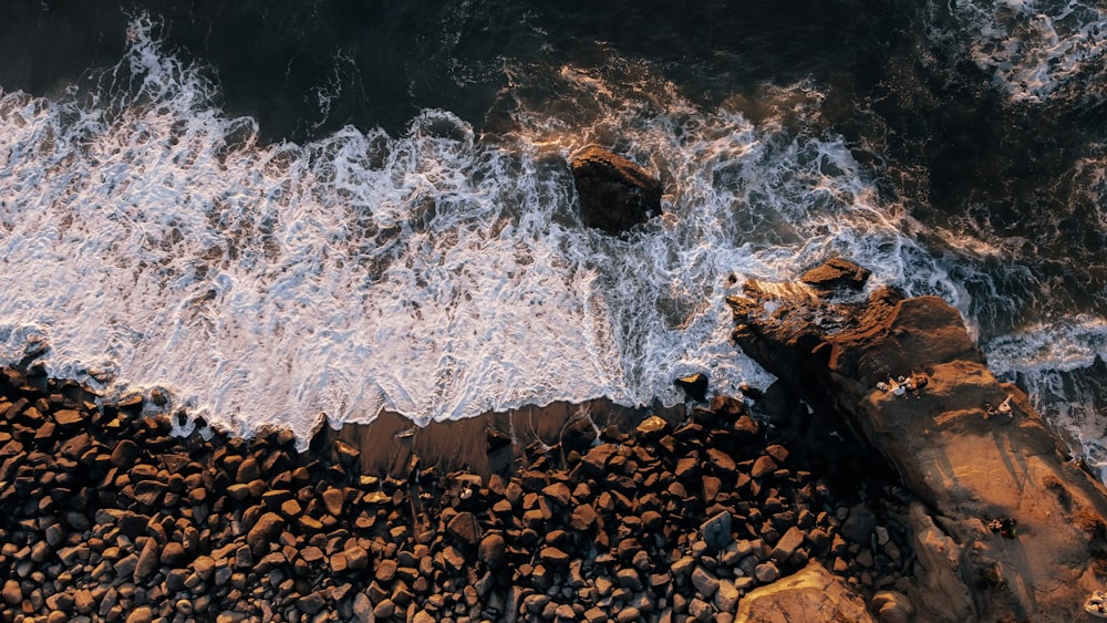 brown rocks on water during daytime