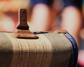 Close-up of a vintage suitcase with travel stickers from around the world.