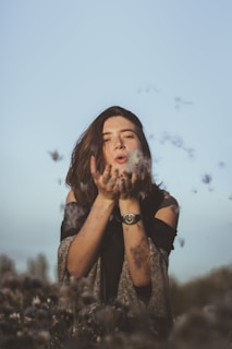 woman in black and white floral dress with white powder on her face