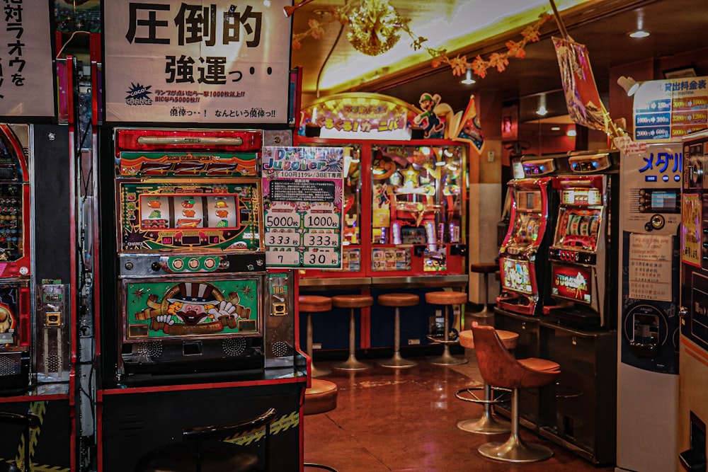 arcade machine near brown wooden chair