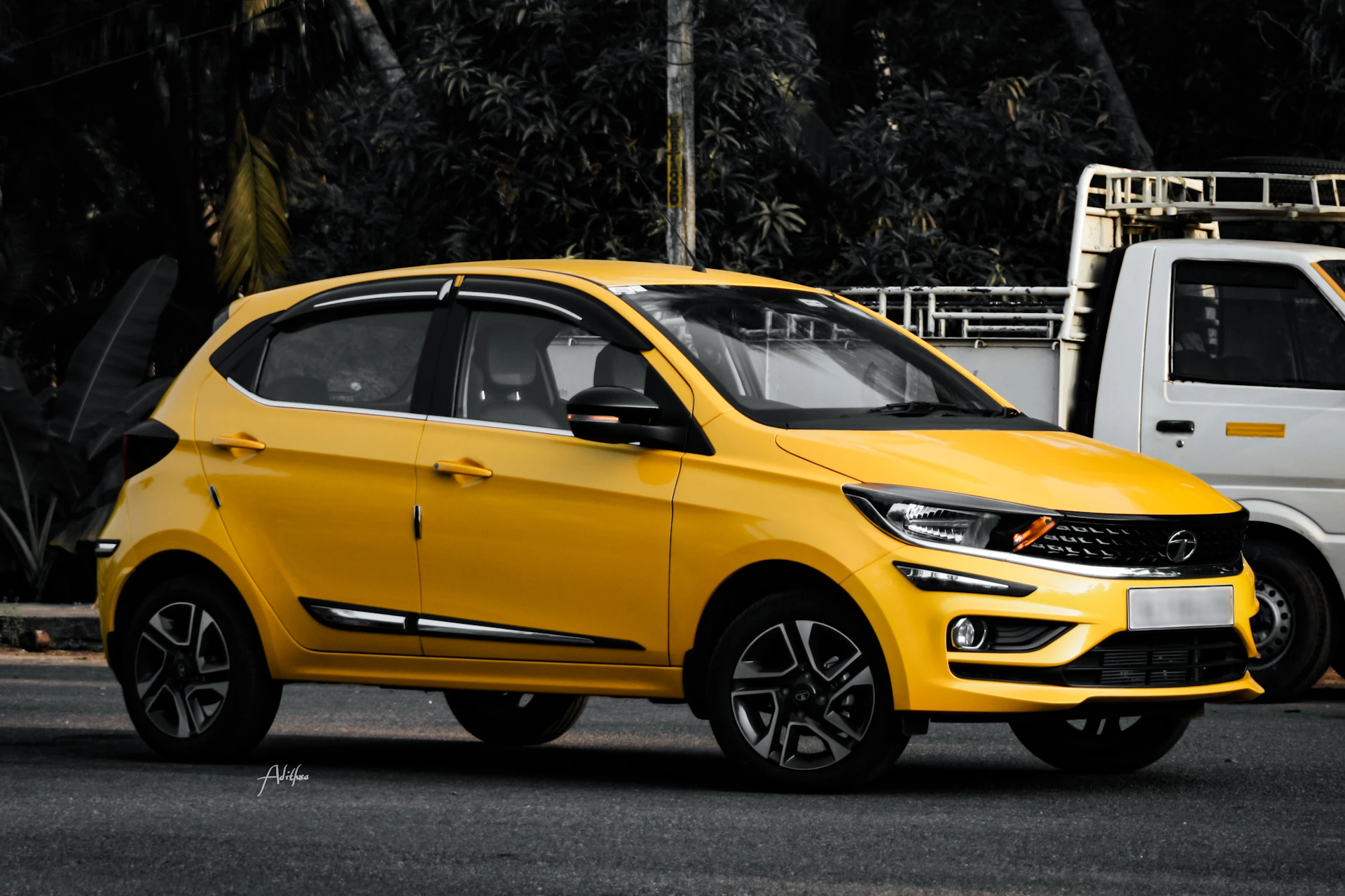 yellow 5 door hatchback on road
