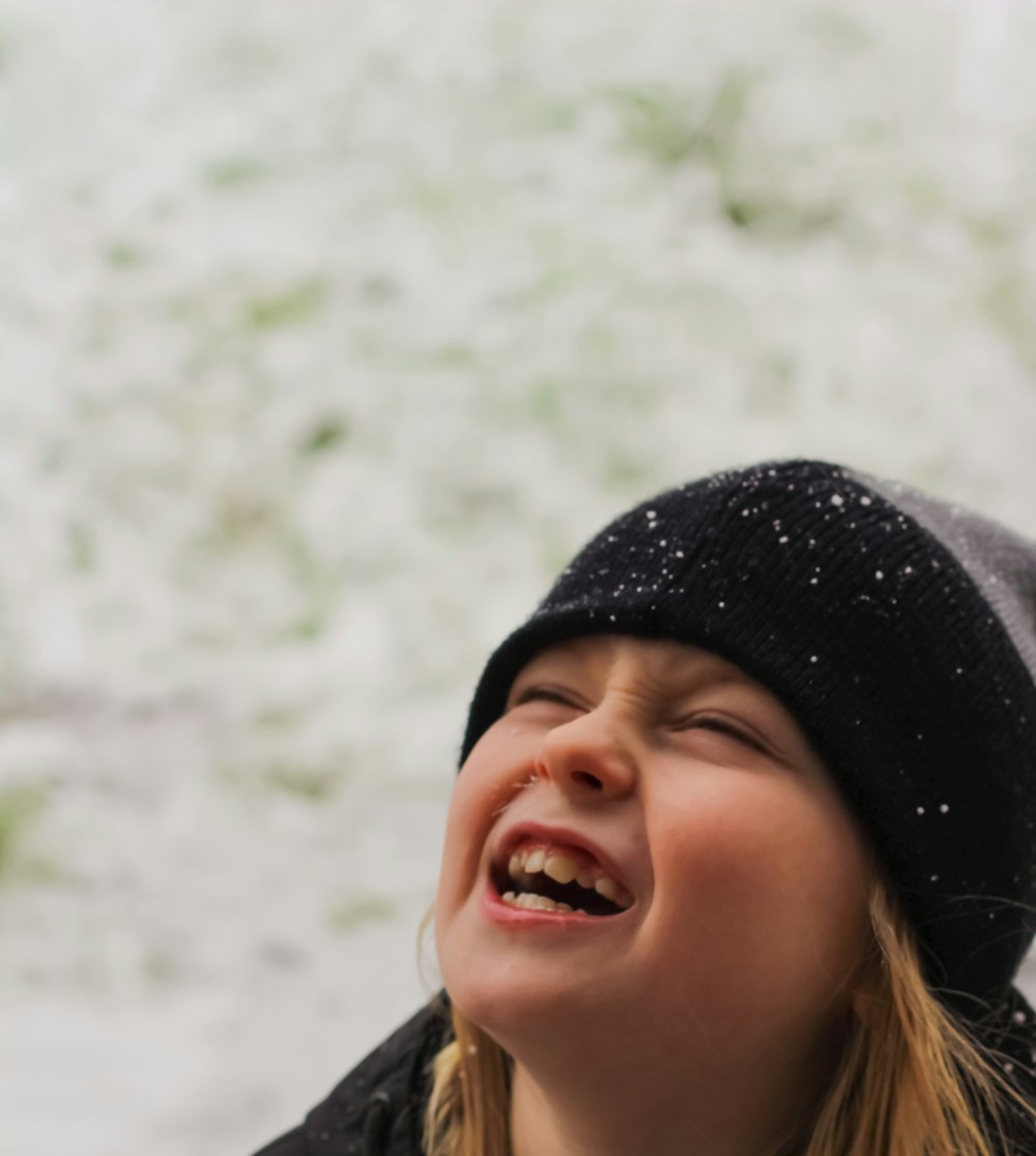 smiling girl in black knit cap