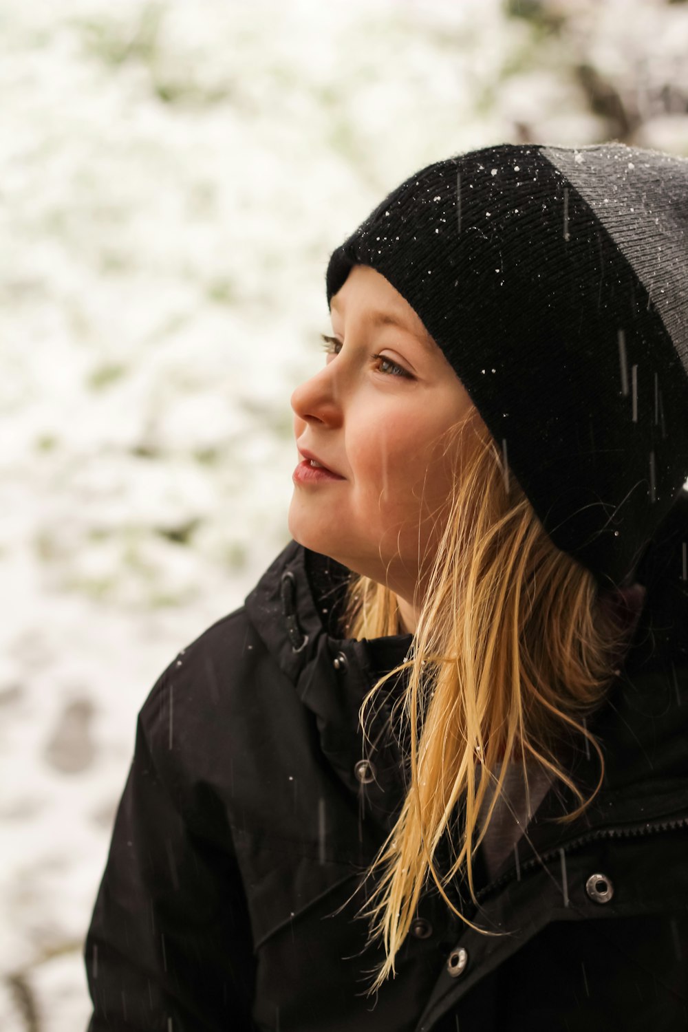 woman in black knit cap and black jacket