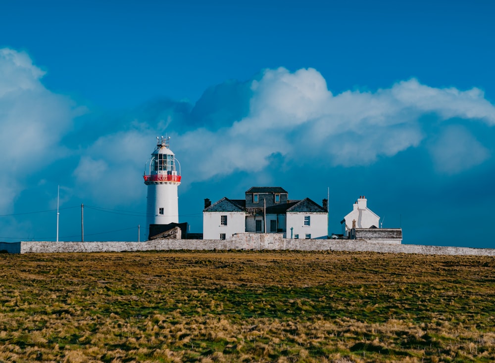 white and red lighthouse under blue sky during daytime