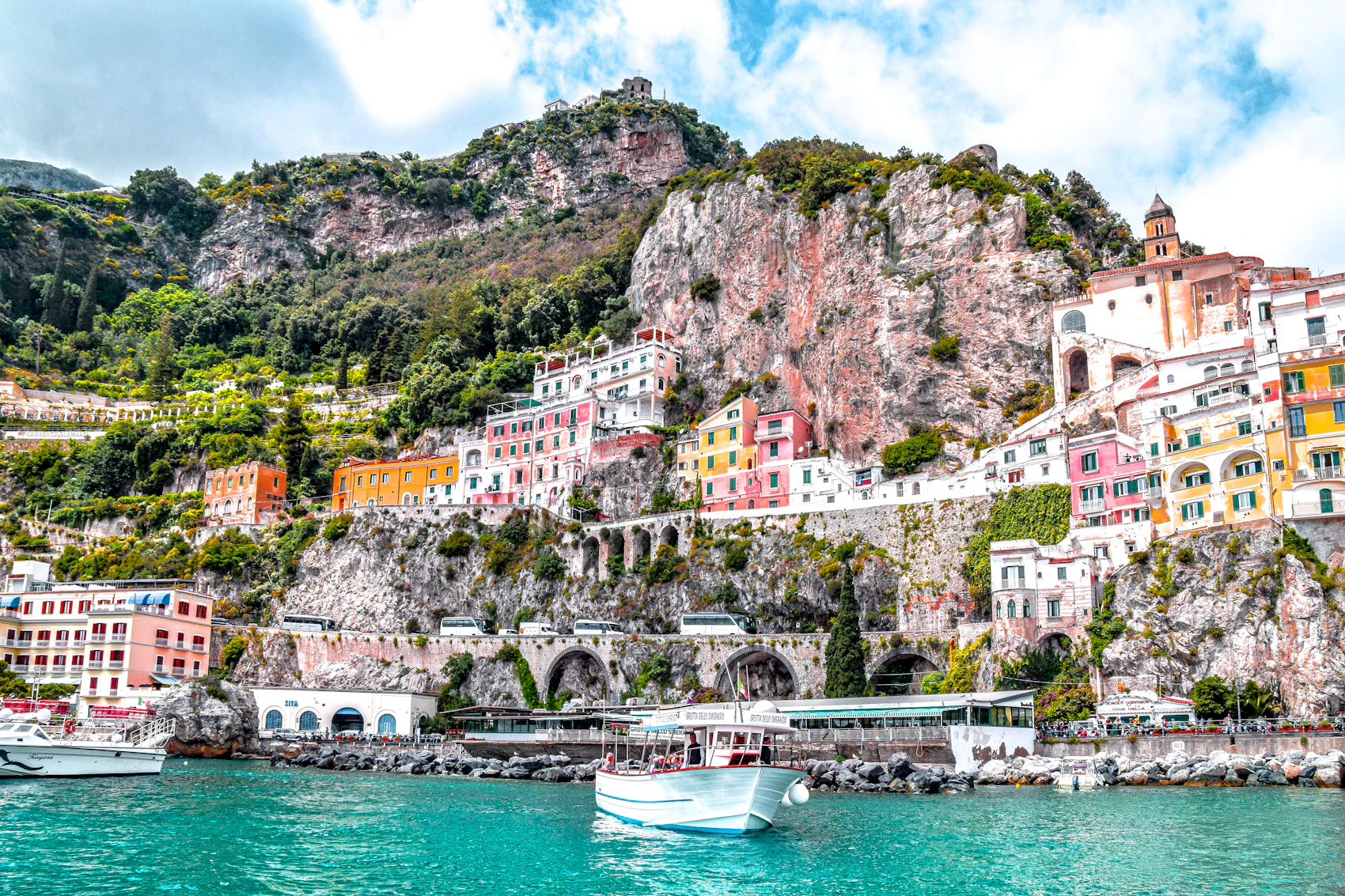 A colourful town rising above the blue water of the Amalfi Coast
