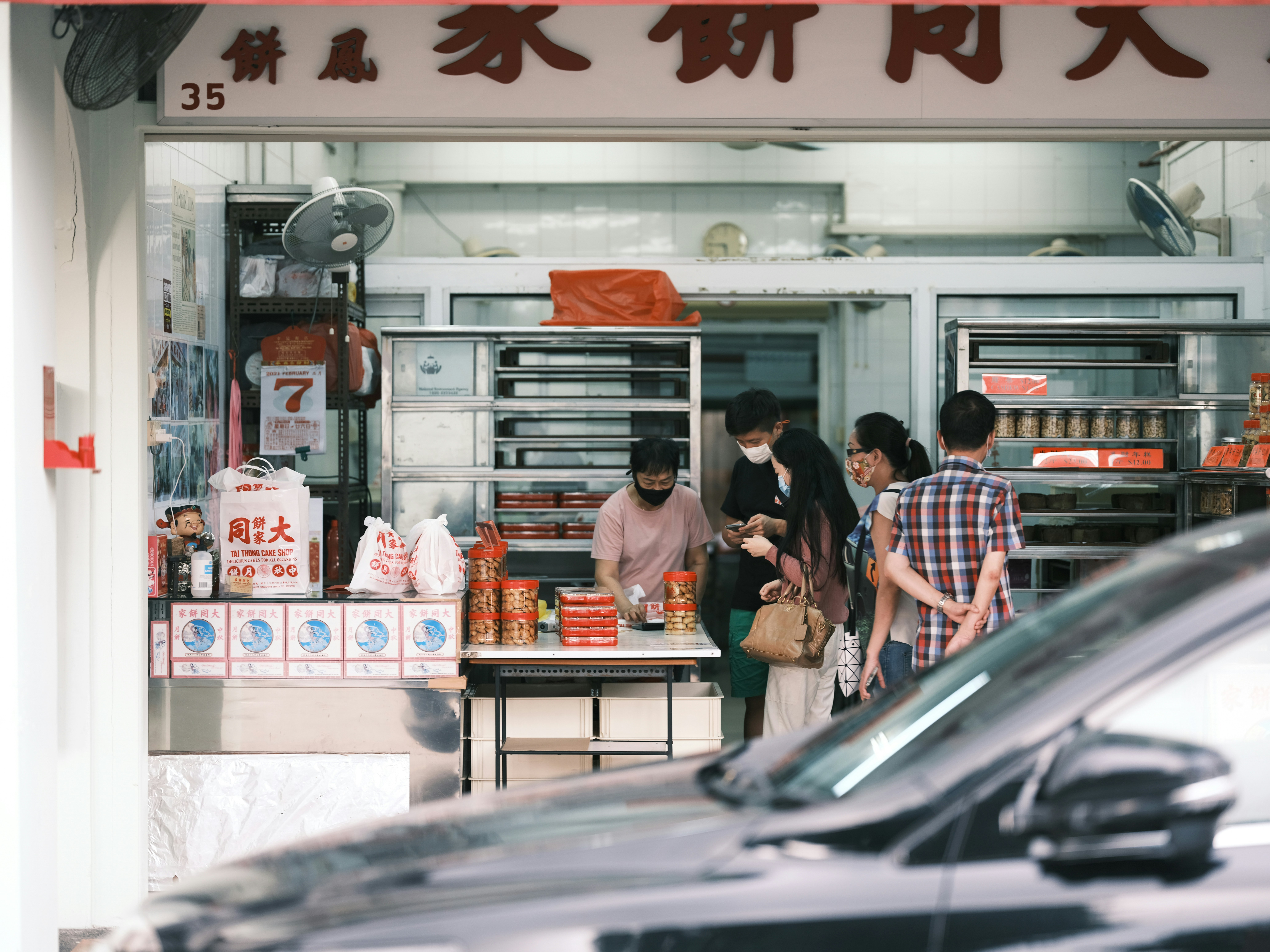 people standing in front of store during daytime, 
