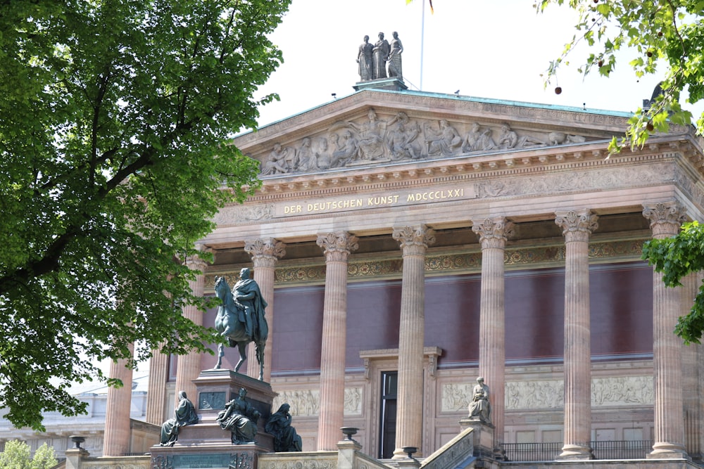 beige concrete building with statue of man riding horse statue