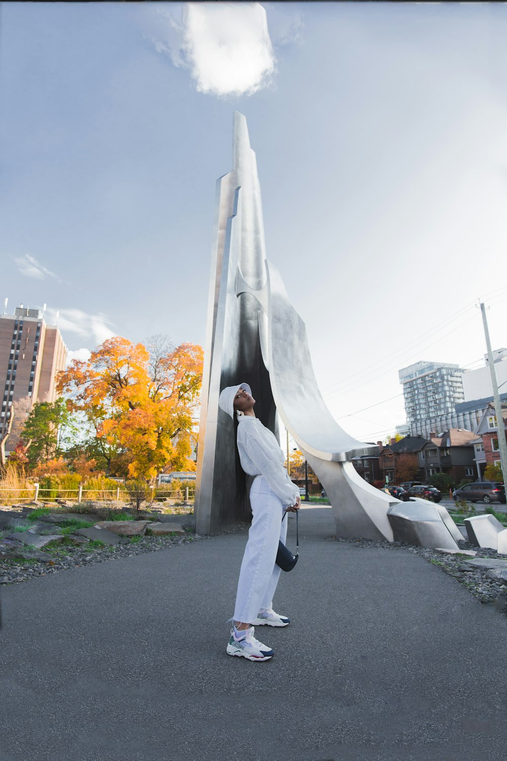 man in white pants walking on street during daytime