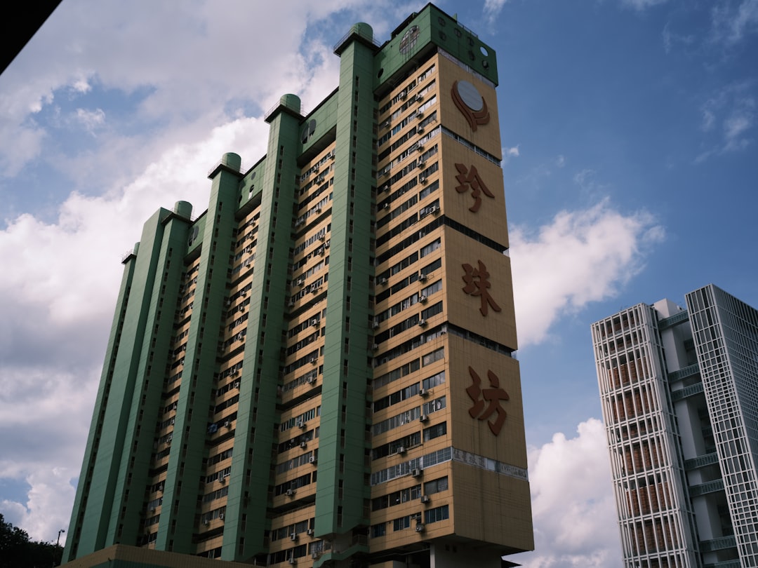 green and brown concrete building under blue sky during daytime