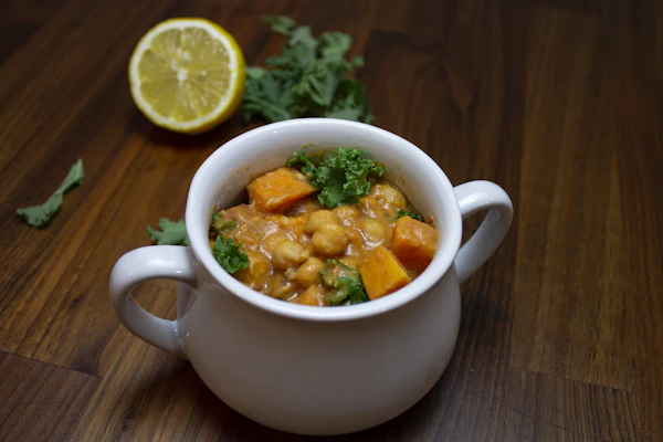 Warm lentil and herb comfort bowl with sweet potato and kale