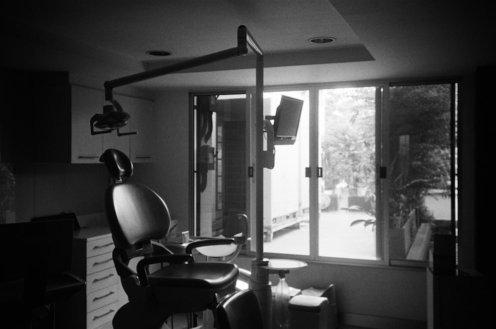grayscale photo of barber chairs