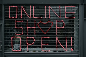 A small business owner happily registering their shop online using oeac network’s business service.