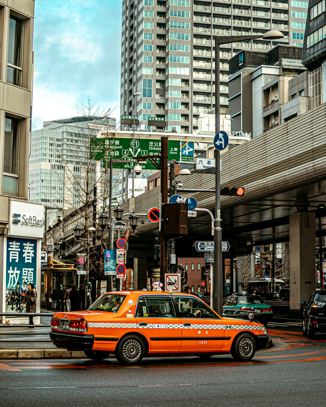 red sedan on road near buildings during daytime