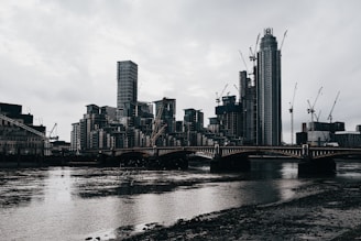 Modern city skyline with cranes and new construction projects.