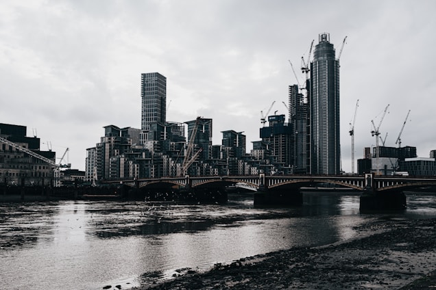 A modern city skyline with construction cranes and real estate buildings under development.