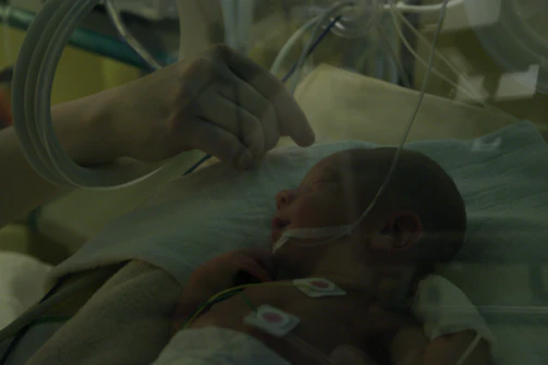 Doctors attentively monitoring a baby’s vital signs with warm smiles.