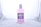 A bottle of Enliven Total Care Mouthwash is centered against a plain, light-colored background. The mouthwash is pink and packaged in a clear plastic bottle with a white cap. The label is predominantly purple and white, providing information about the product, such as its 6 benefits.