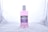 A bottle of Enliven Total Care Mouthwash is centered against a plain, light-colored background. The mouthwash is pink and packaged in a clear plastic bottle with a white cap. The label is predominantly purple and white, providing information about the product, such as its 6 benefits.