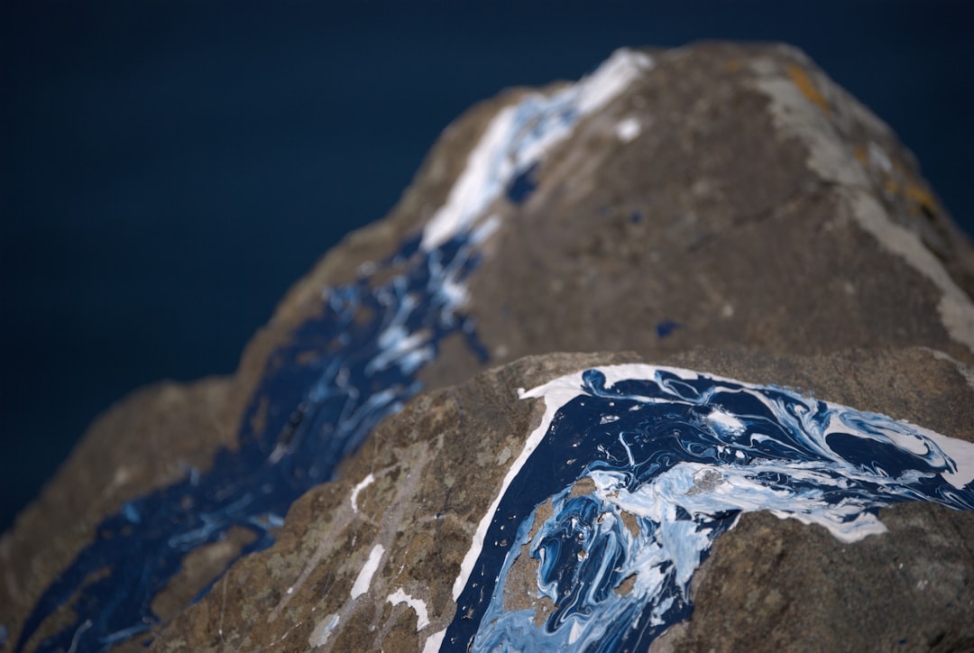 white and blue ice on gray rock