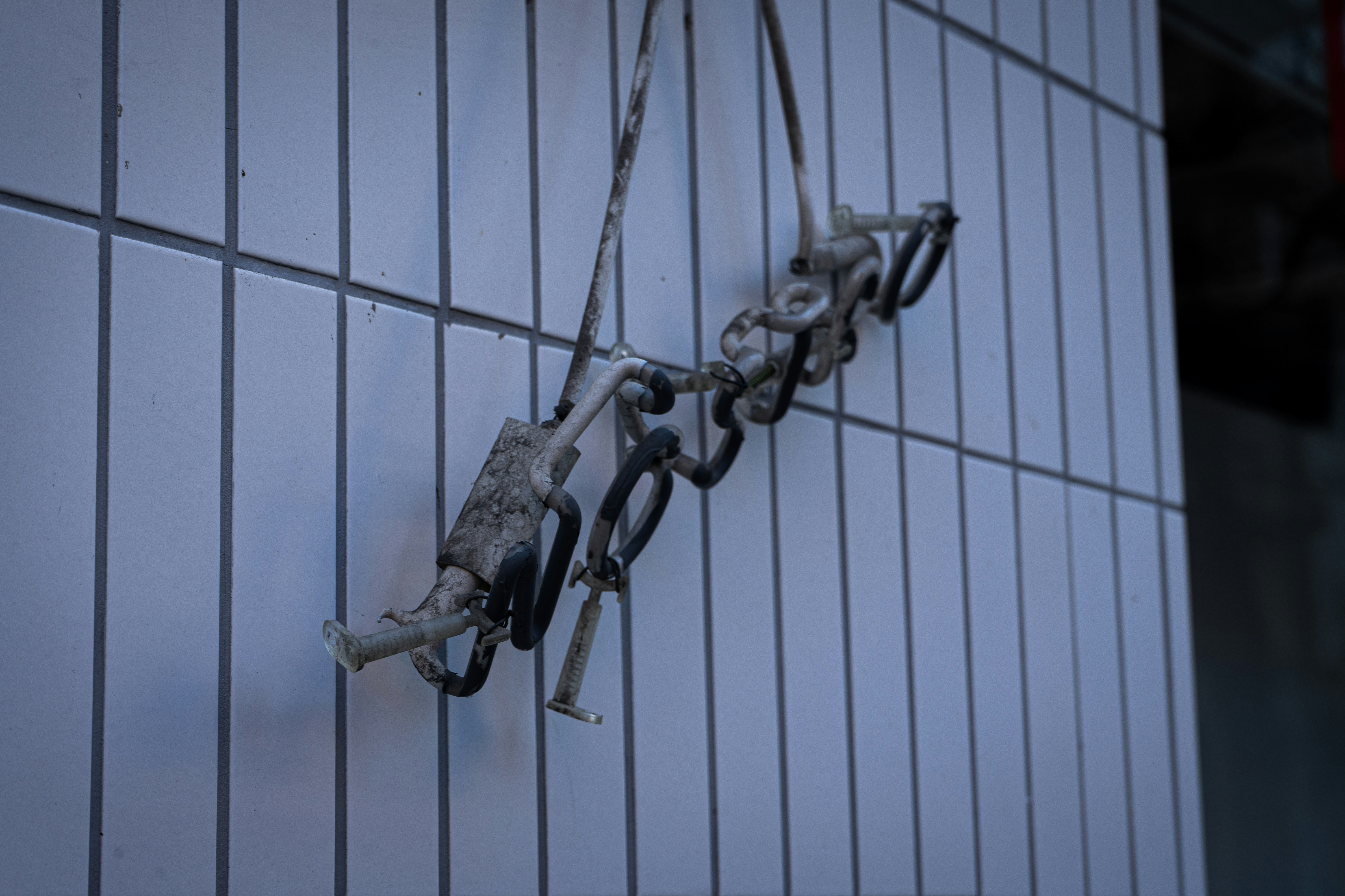 gray metal chain on white metal fence, 