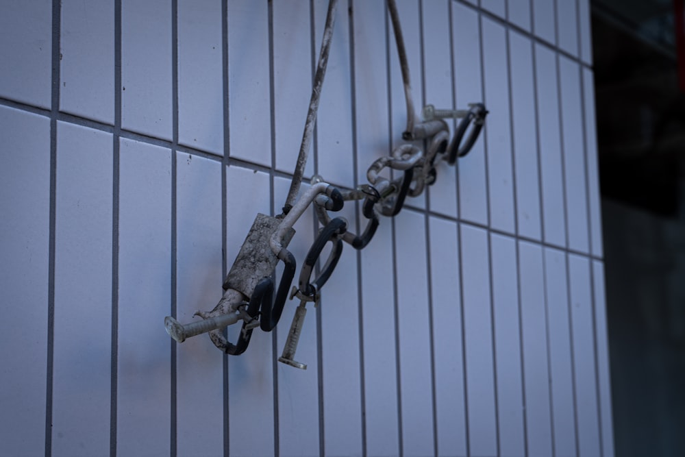 gray metal chain on white metal fence