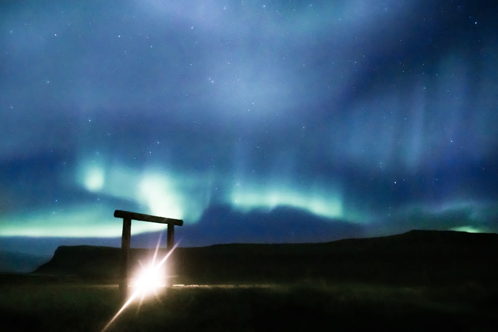 brown wooden bench under starry night