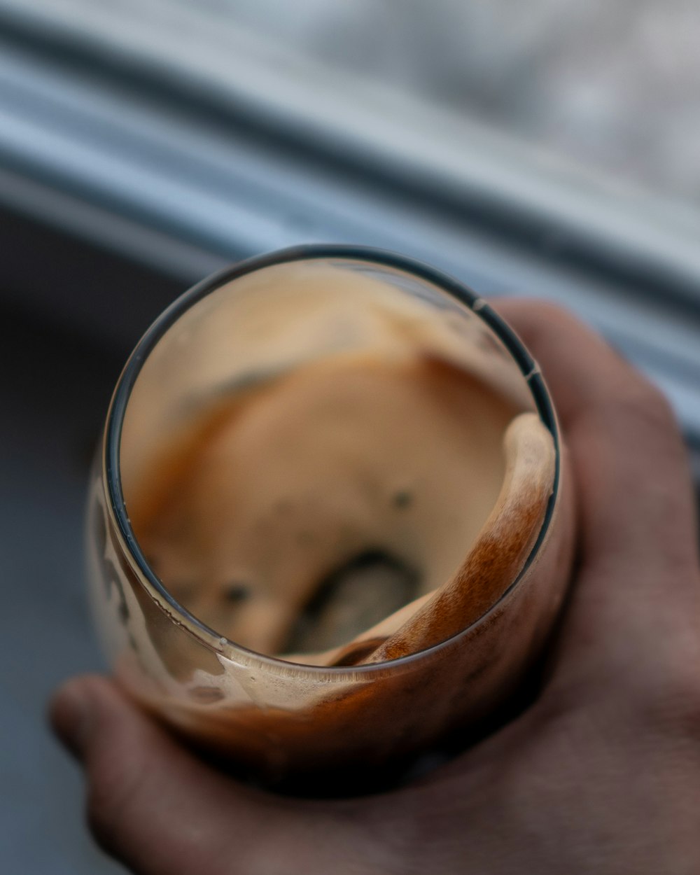 person holding clear drinking glass