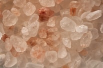 Workers carefully sorting and packaging Himalayan pink salt in a clean facility.