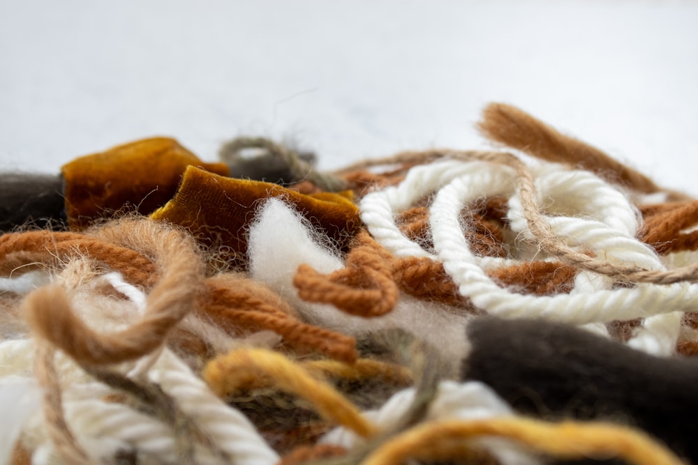 white and brown rope on white textile