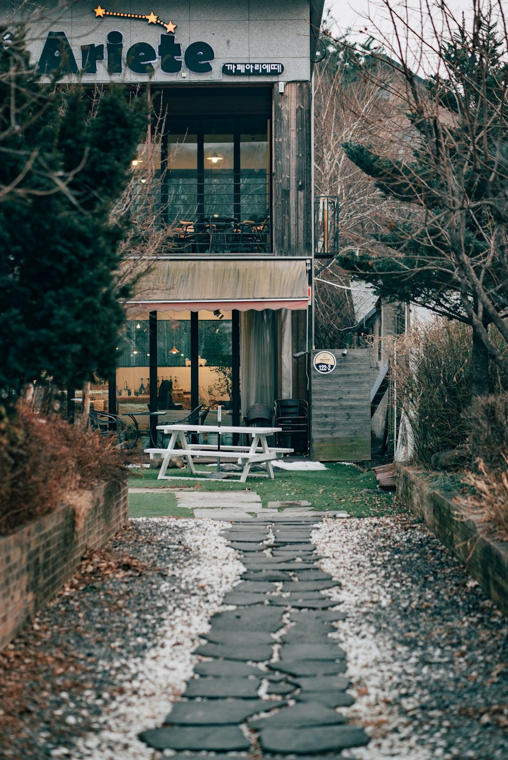 brown wooden house near trees during daytime