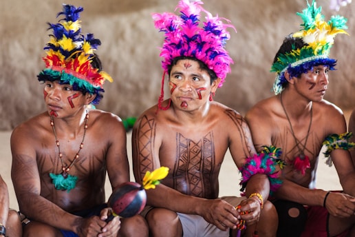 2 women in purple and yellow floral headdress