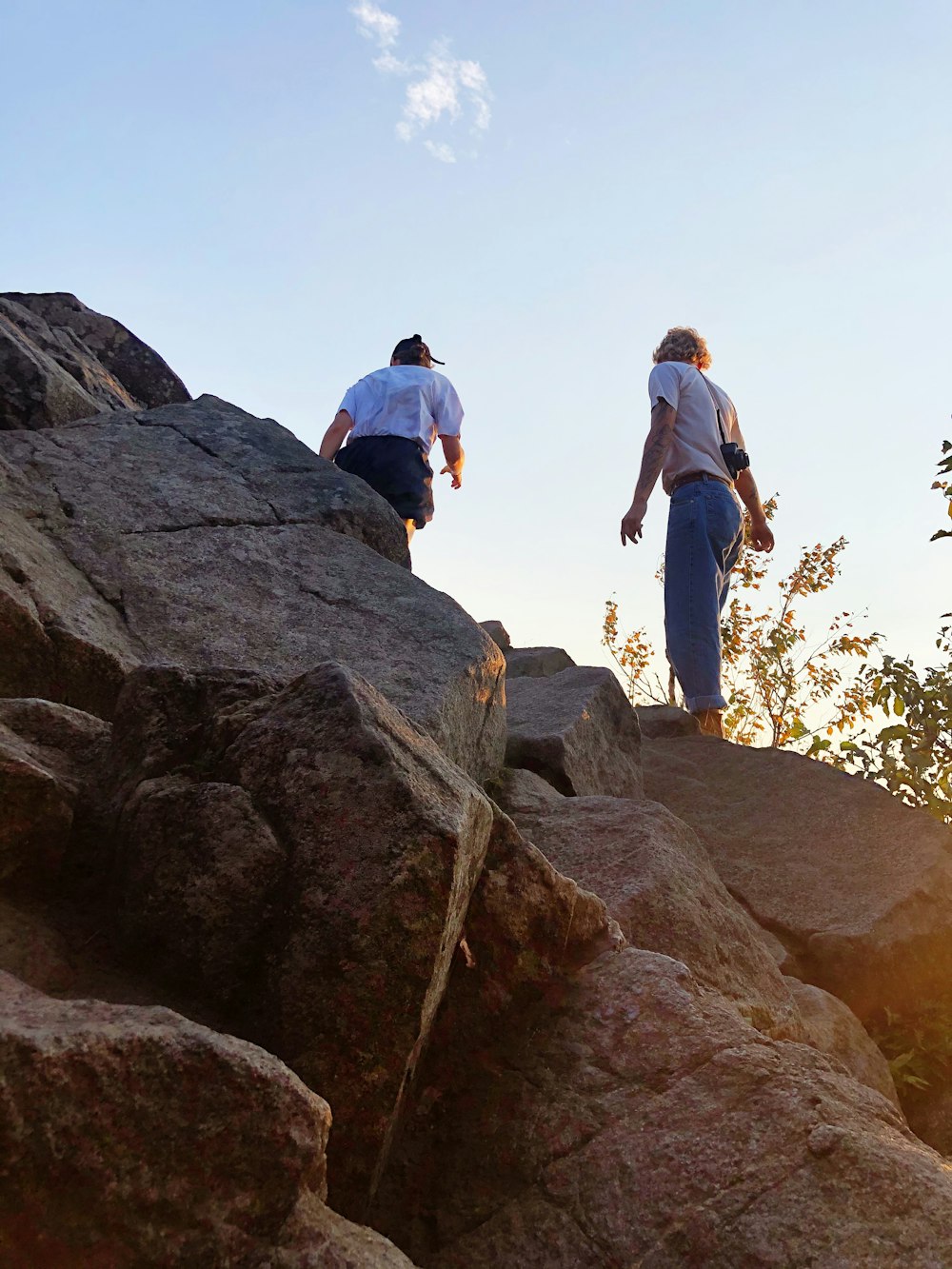 man and woman standing on rock formation during daytime