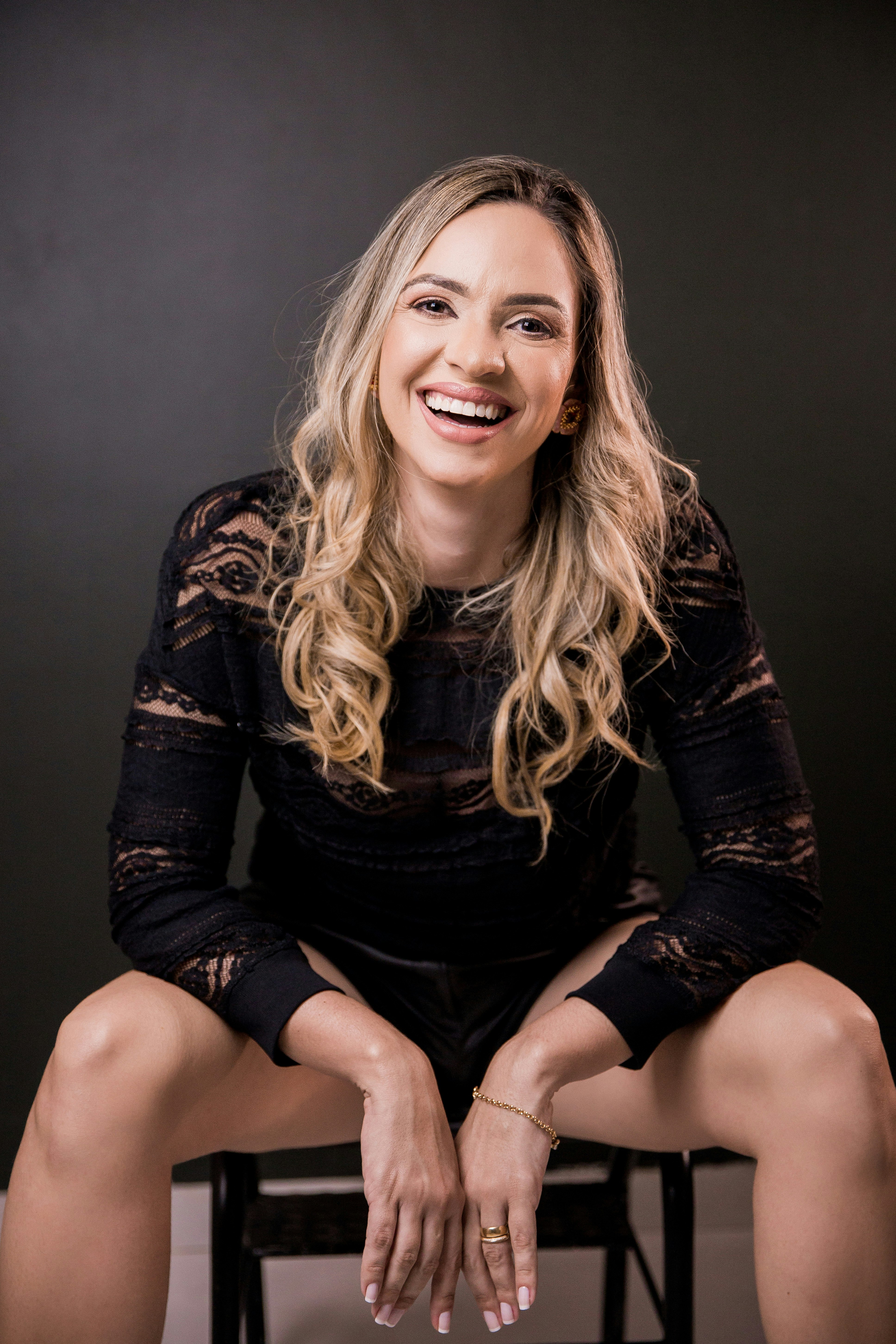 woman in black long sleeve shirt and black shorts sitting on floor