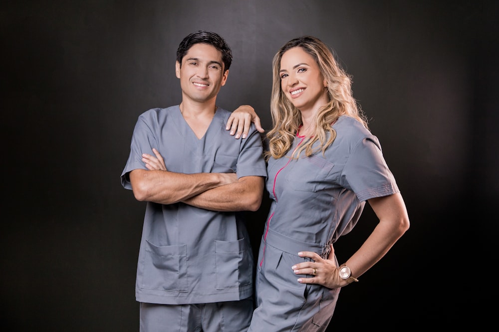 man in gray polo shirt standing beside woman in gray dress