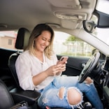 woman in white shirt and blue denim jeans sitting on car seat