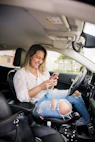 woman in white shirt and blue denim jeans sitting on car seat