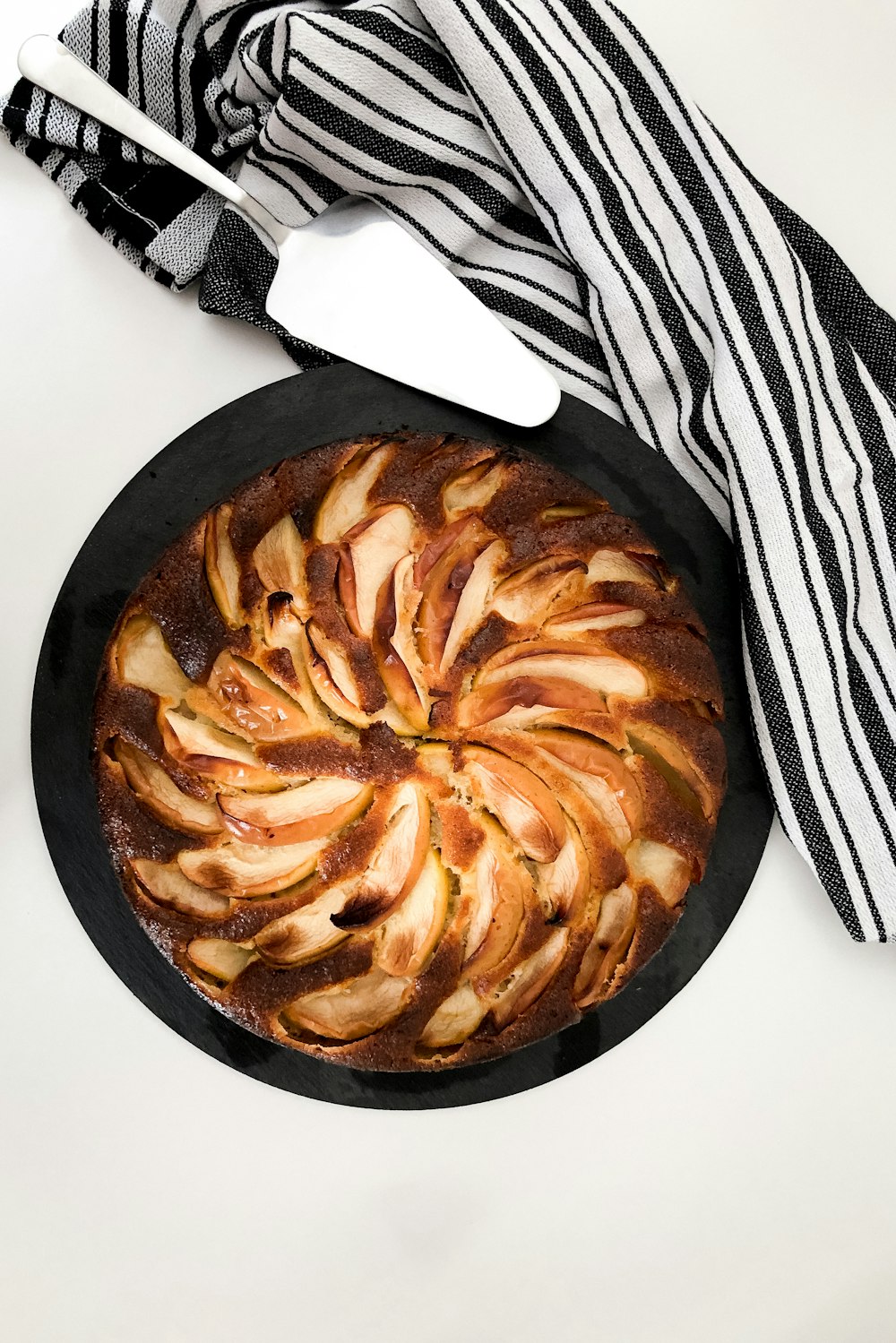 brown and white pastry on black plate