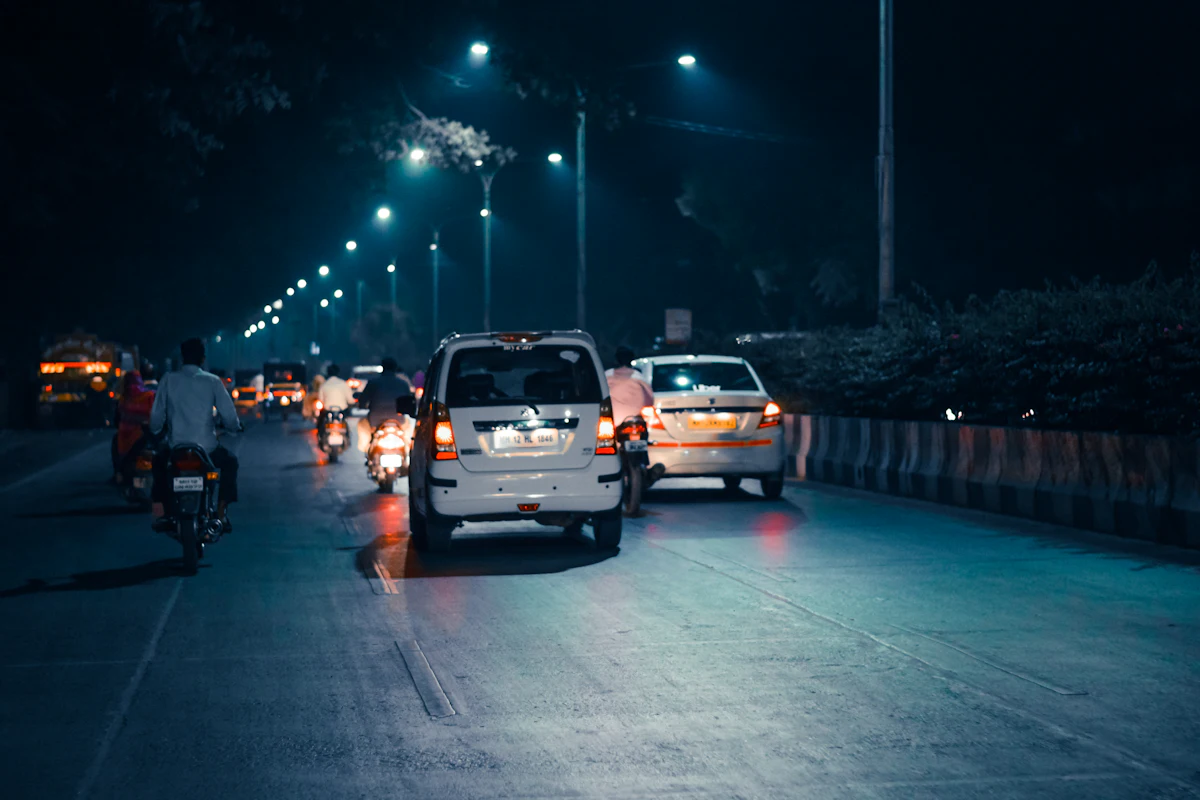Cars and motorcycles on a city road at night