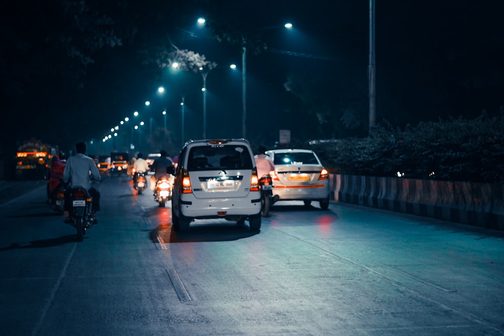 white suv on road during night time