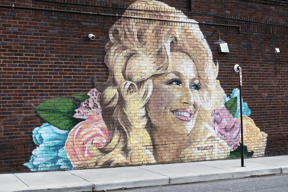 woman and girl painting on wall