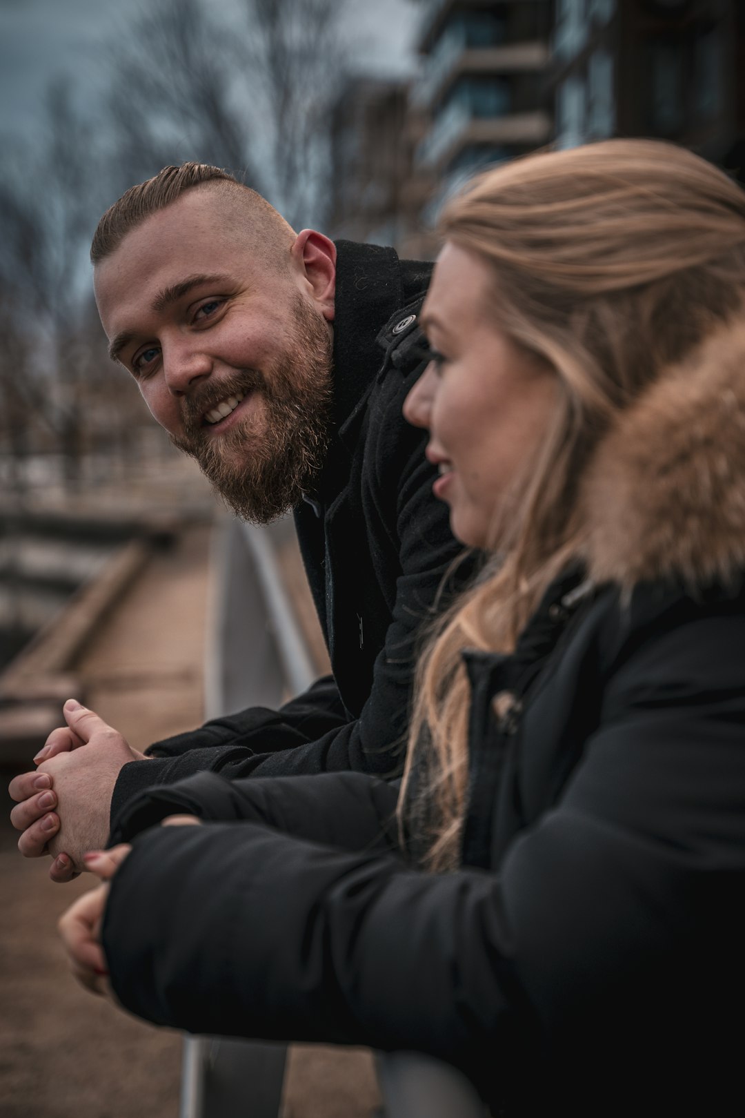 man in black jacket standing beside woman in black jacket